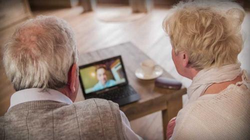 Elderly couple video chat with a family member