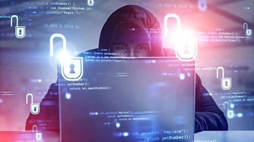 Cybersecurity_at_home.jpg Hacker behind a laptop