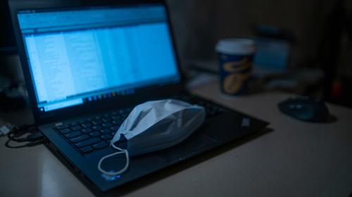 dimitri-karastelev-0hO1QgI1H8g-unsplash.jpg Surgical mask sitting on top of a laptop keyboard.