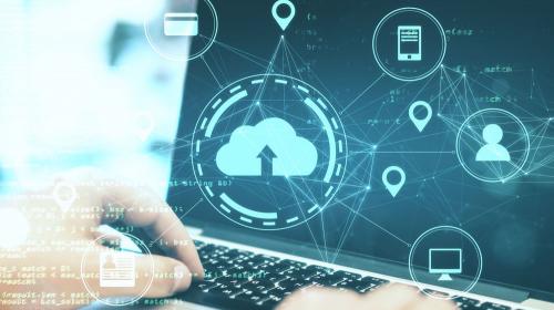 Hands on keyboard with digital image on screen