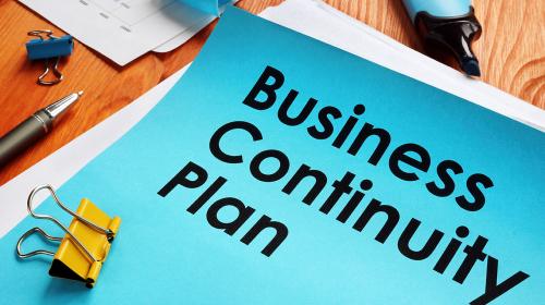 Business Continuity Plan Business Continuity Plan written on blue paper with office supplies surrounding