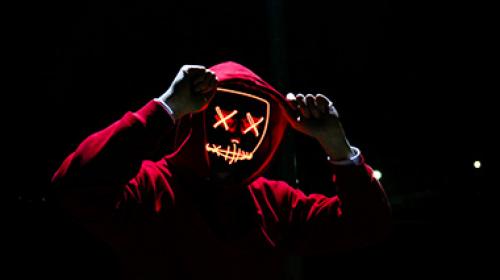 Hacker in red hoodie with X's for eyes