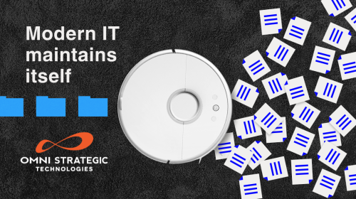 A robotic vacuum is centered on a textured dark surface, surrounded by scattered papers with blue lines. Text on the left reads, "Modern IT maintains itself." The Omni Strategic Technologies logo is visible at the bottom.